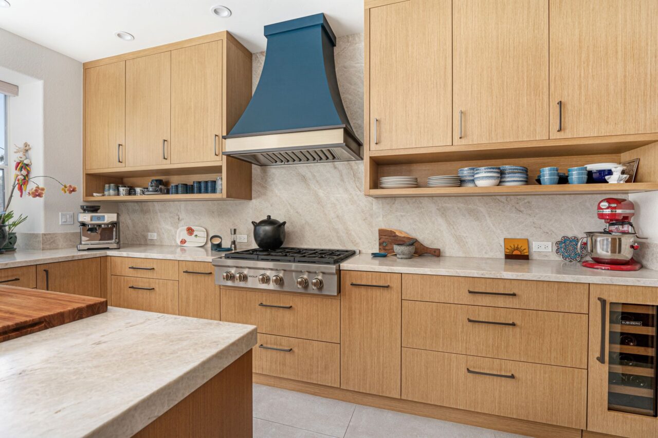 Comfortable eco friendly contemporary kitchen using slab doors that mimic Rift Cut White Oak.