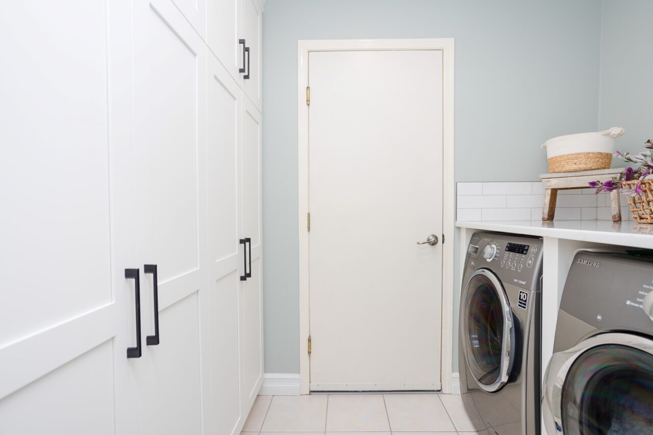White Shaker pantry cabinets in laundry room.